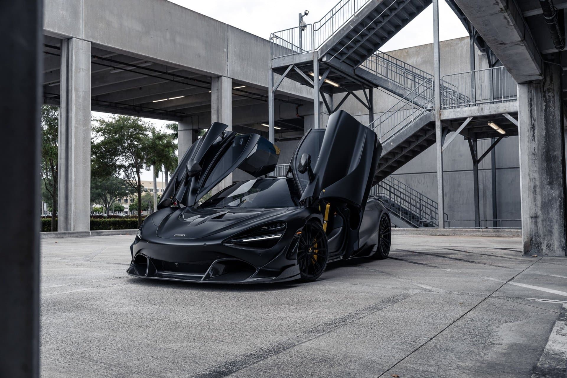 Black sports car with its doors open